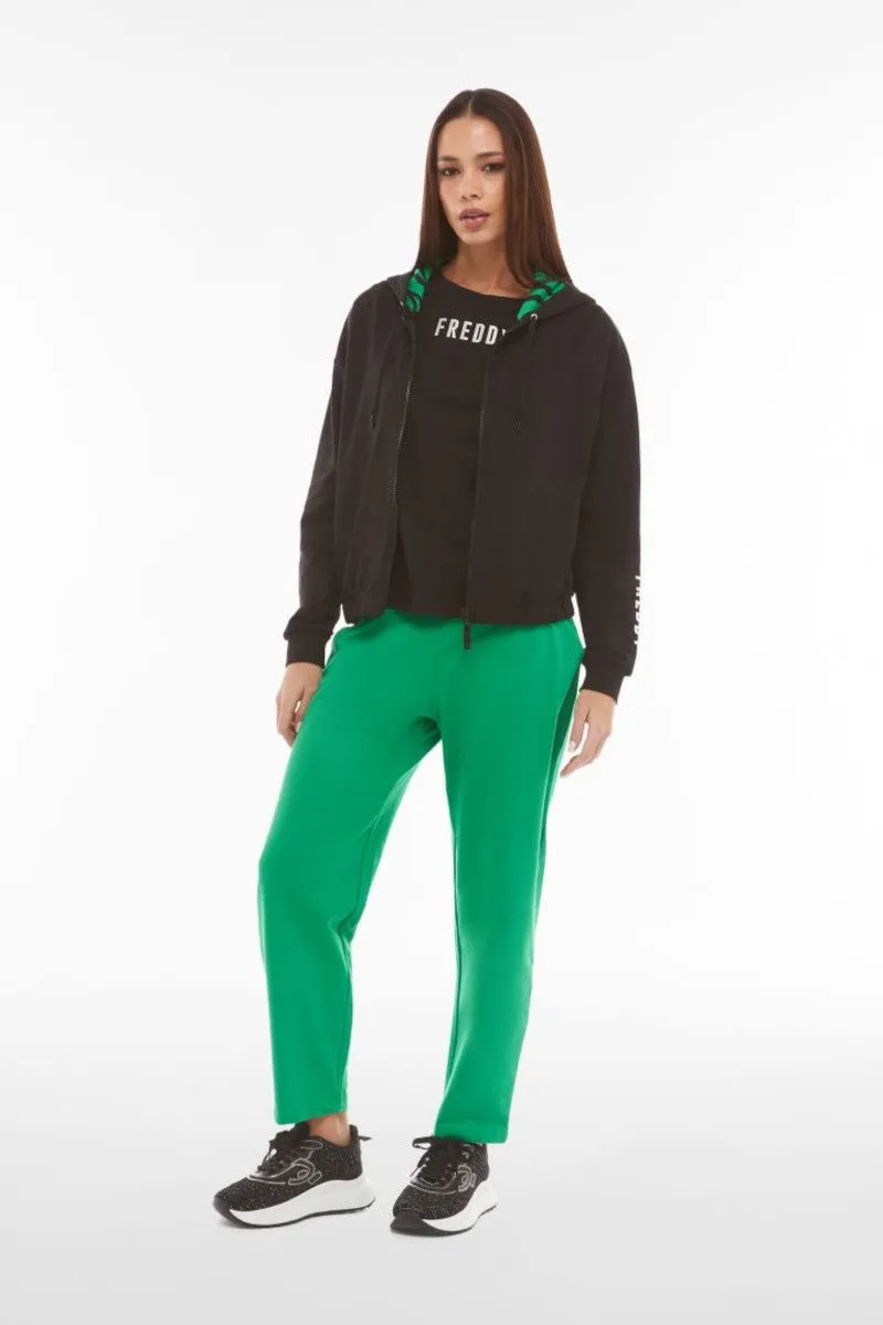 Pantaloni carrot fit in french terry con grafica sul fondo Verde